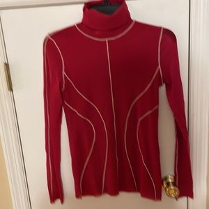 Red designer turtle neck. Ivory stitching along seams.  Great layering piece.